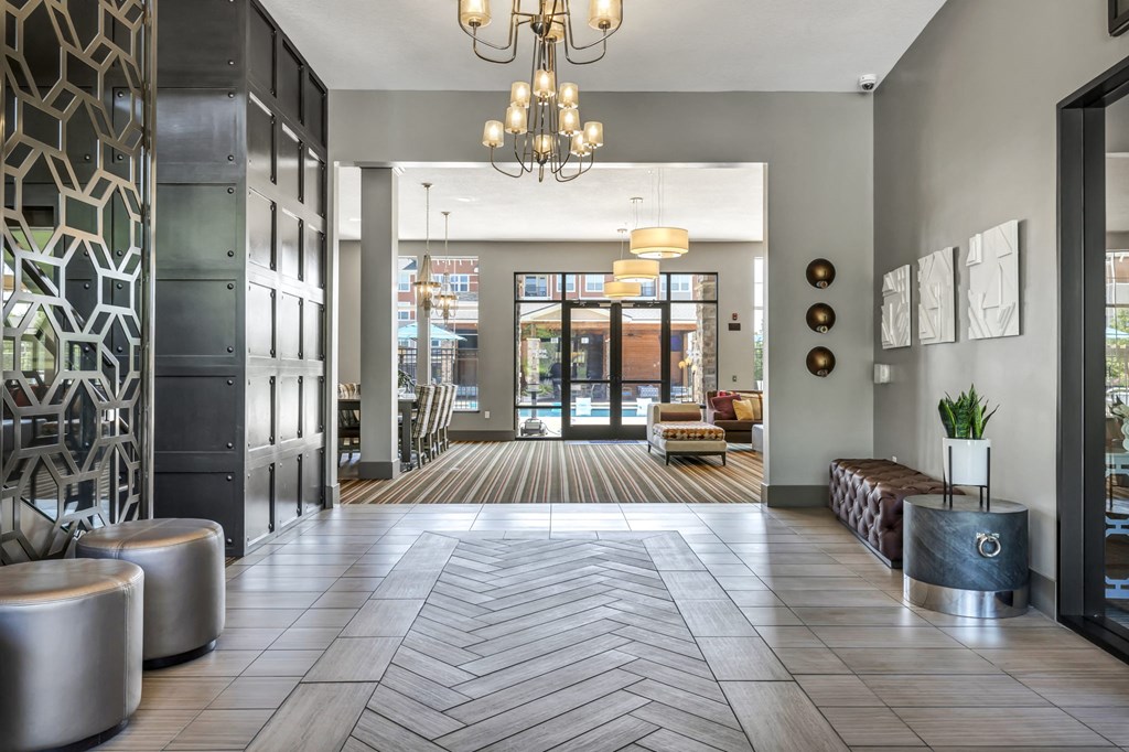 a large lobby with a chandelier and glass doors