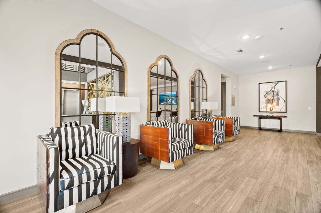 A room with striped chairs and wooden floors.