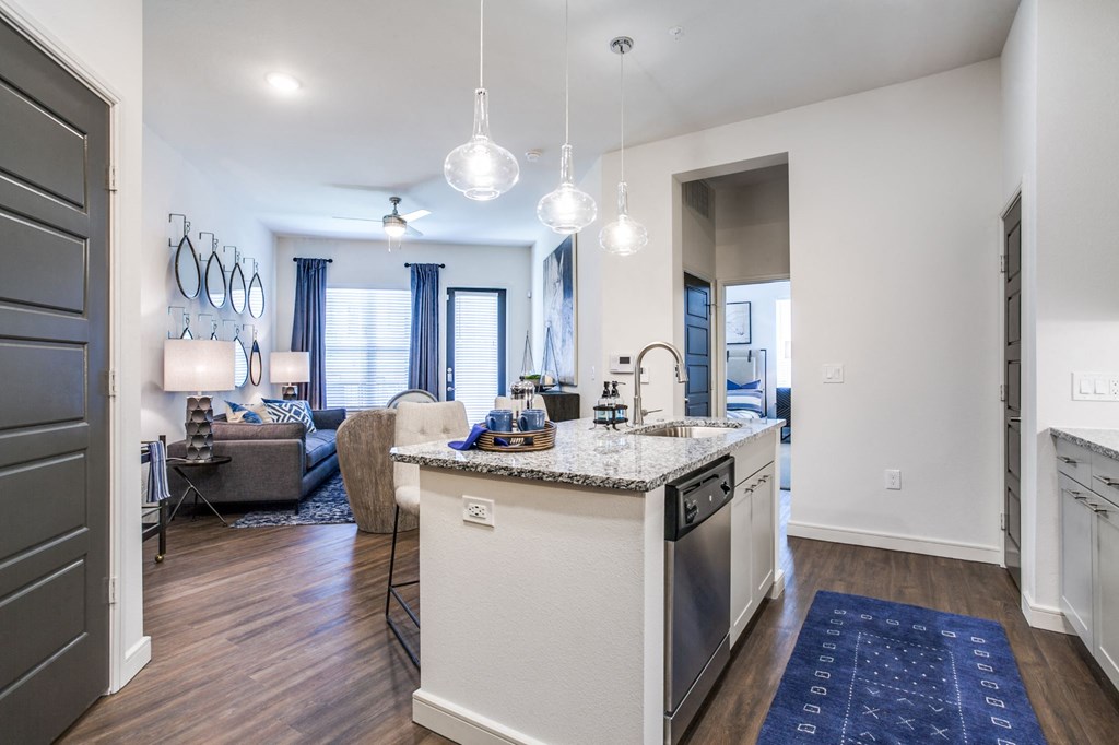 a kitchen with an island and a living room