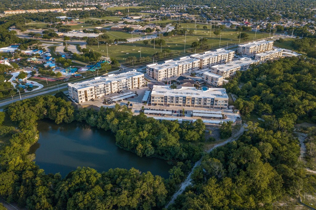 an aerial view of a city with buildings and a lake