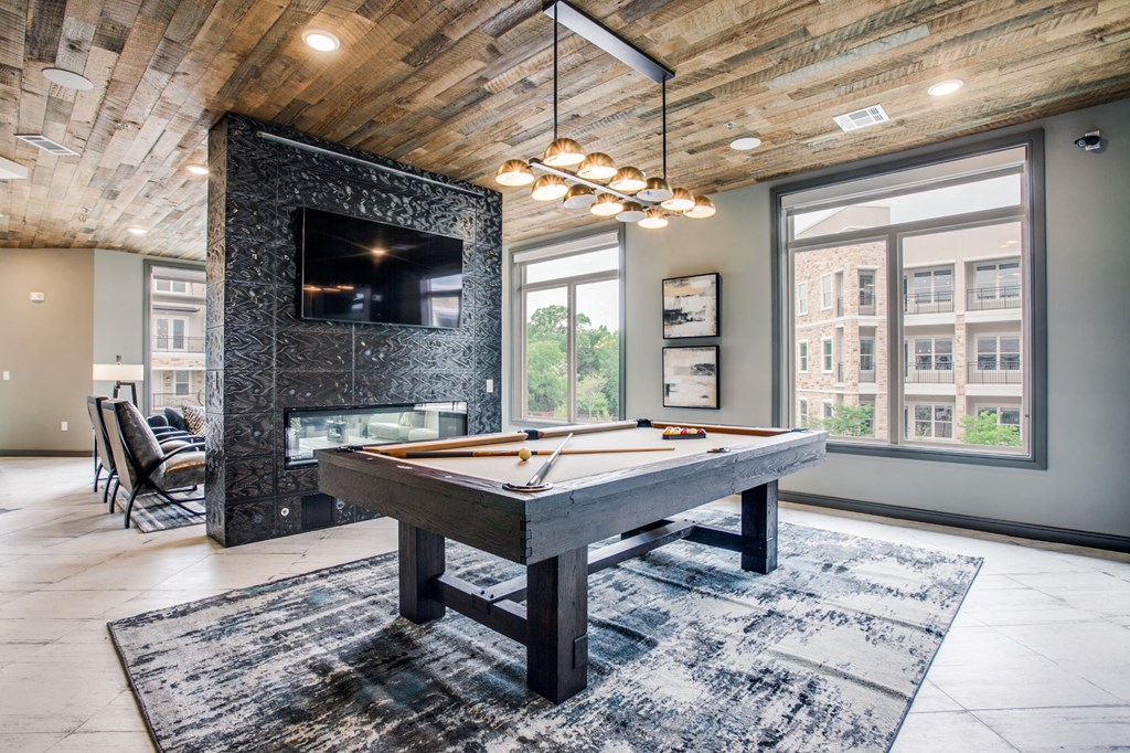 a pool table in a living room with a tv
