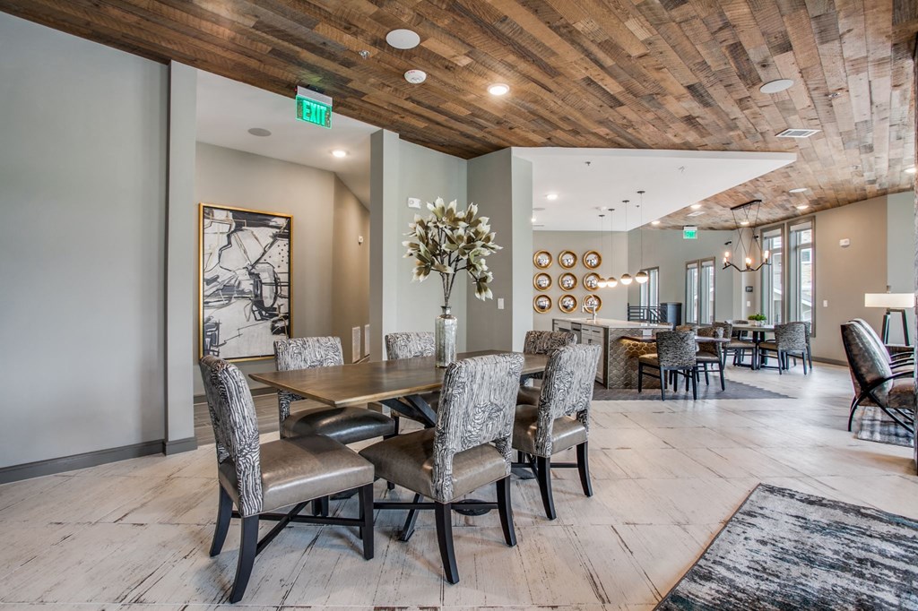 a dining room with a wooden table and chairs