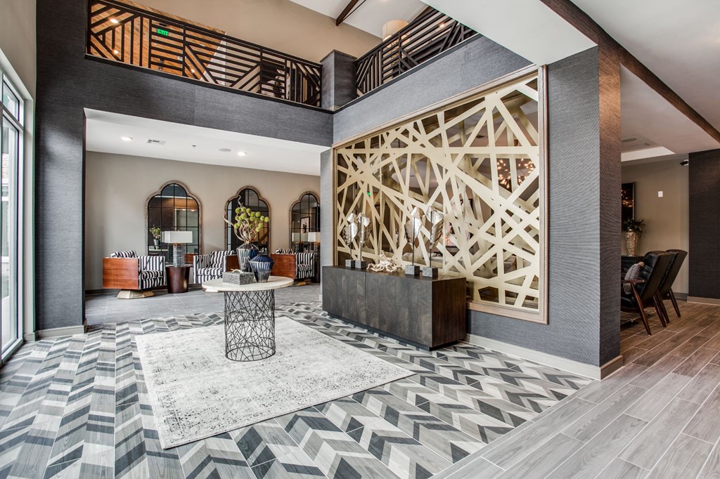a lobby with a reception desk and a geometric design on the wall
