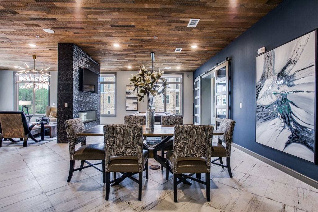 a dining room with a table and chairs and a tv