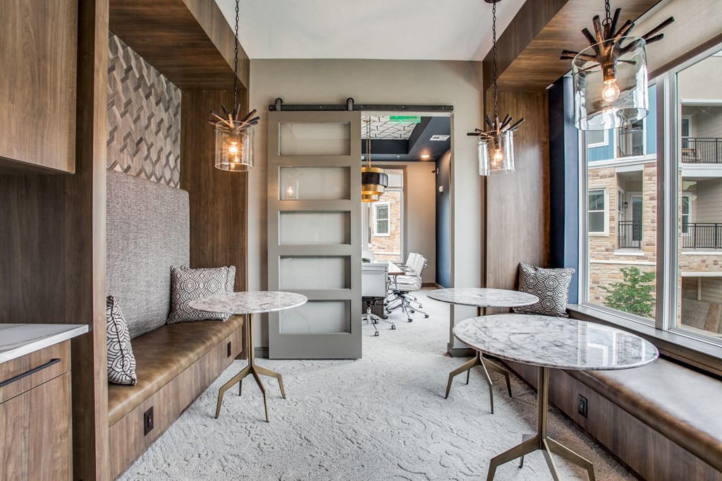 a dining room with tables and chairs and a window