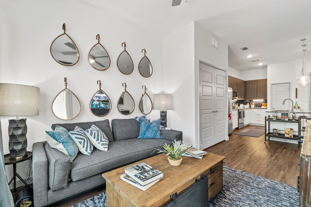 A living room with a grey couch and a coffee table.