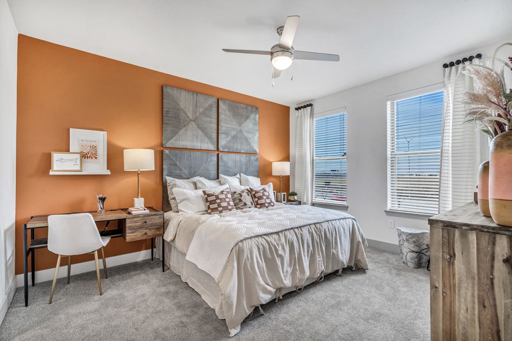 a bedroom with a bed and a ceiling fan