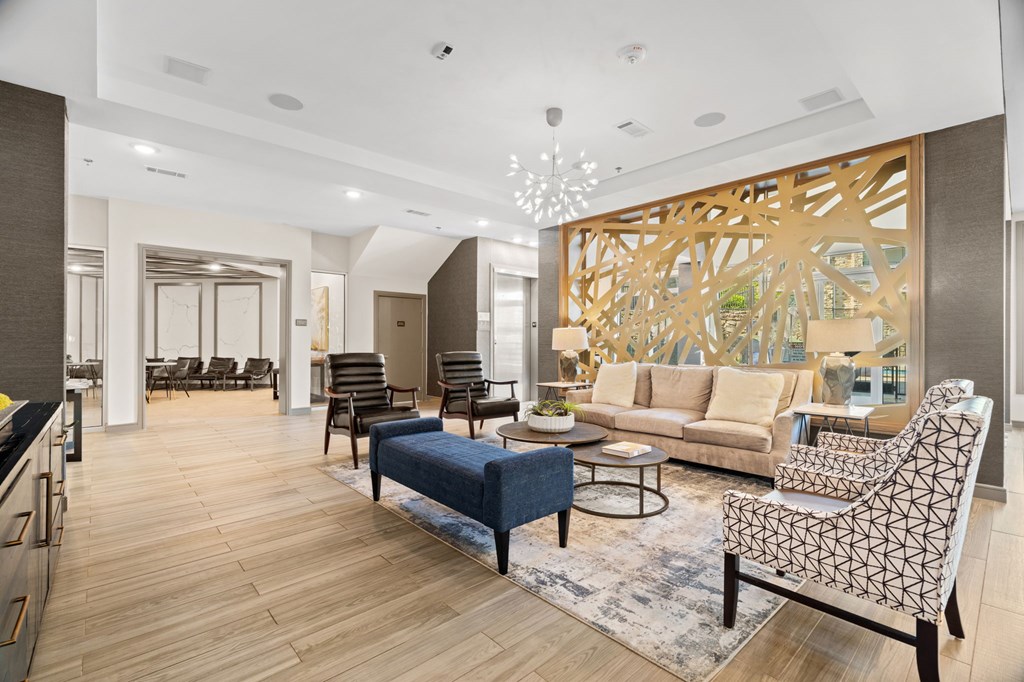 A modern living room with a large abstract tree mural on the wall.