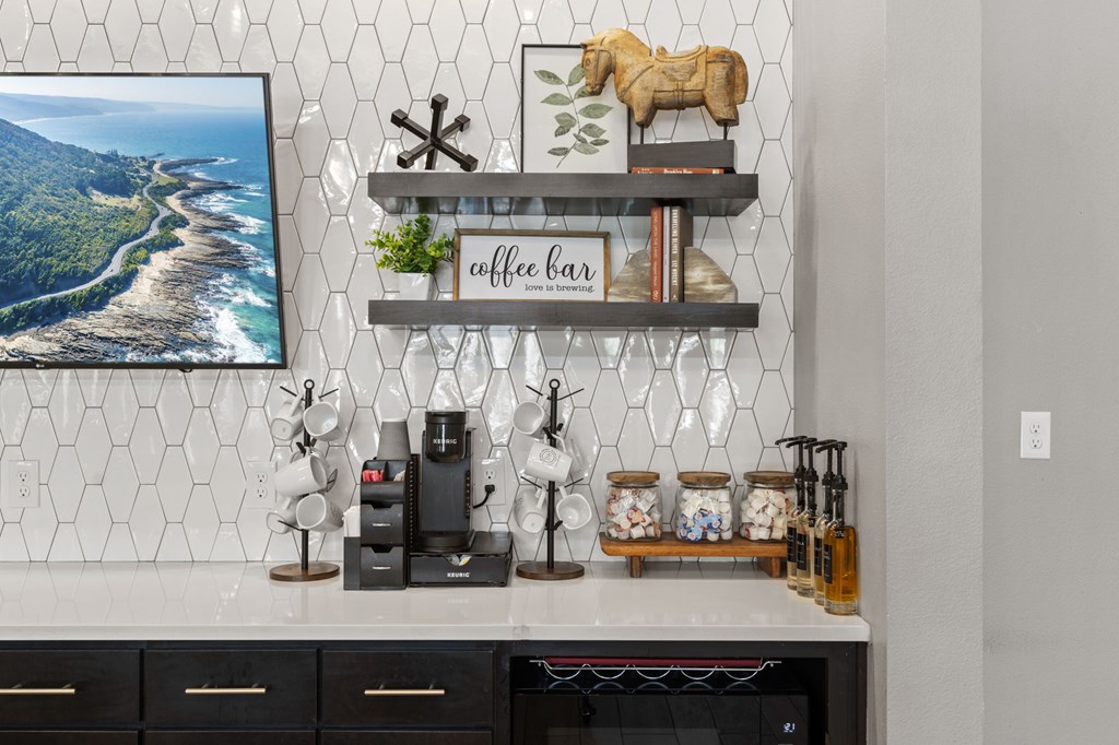 A coffee bar with a framed picture of a coastline on the wall.