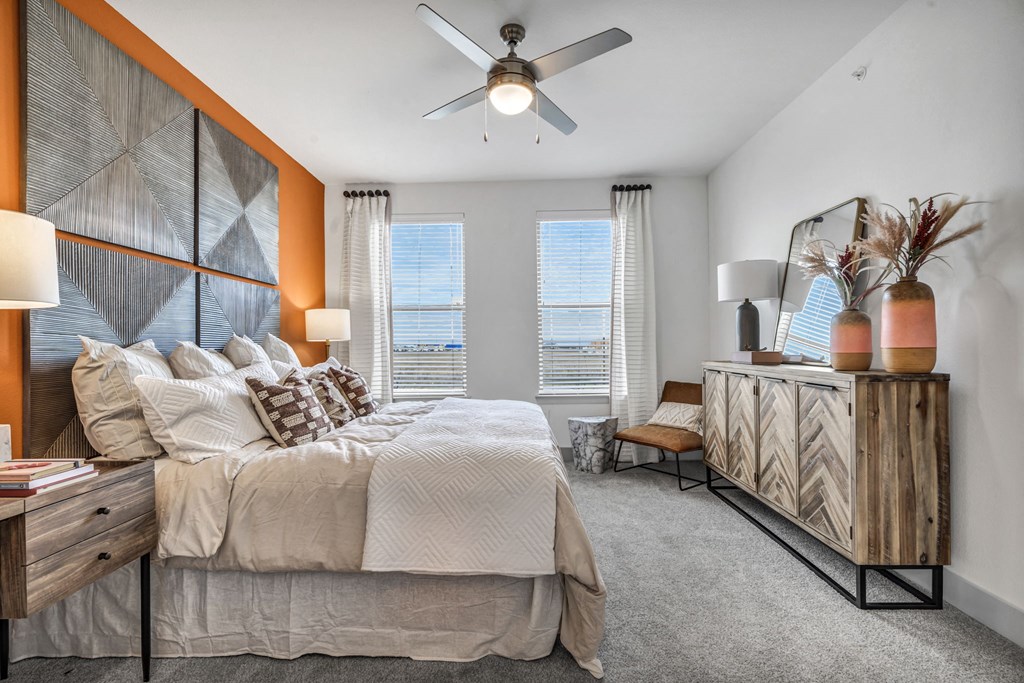 a bedroom with a large bed and a ceiling fan
