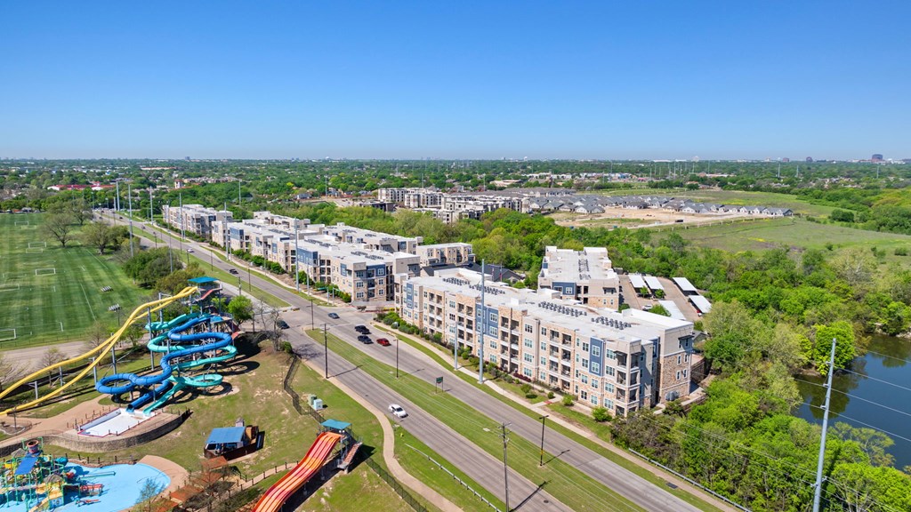 A view of a city with a large building and a water park.