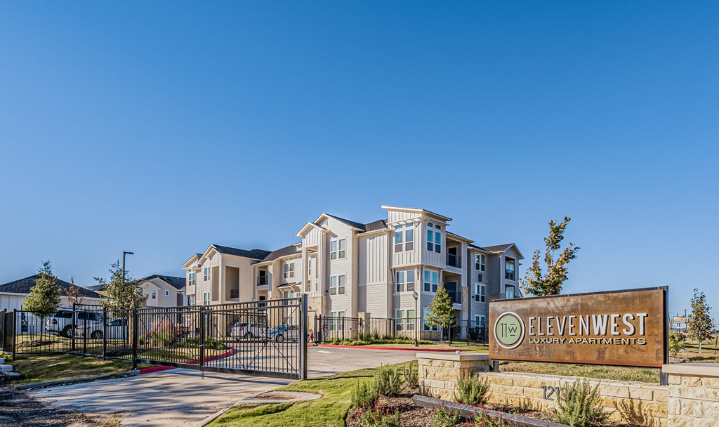 a group of apartment buildings with a sign in front of them