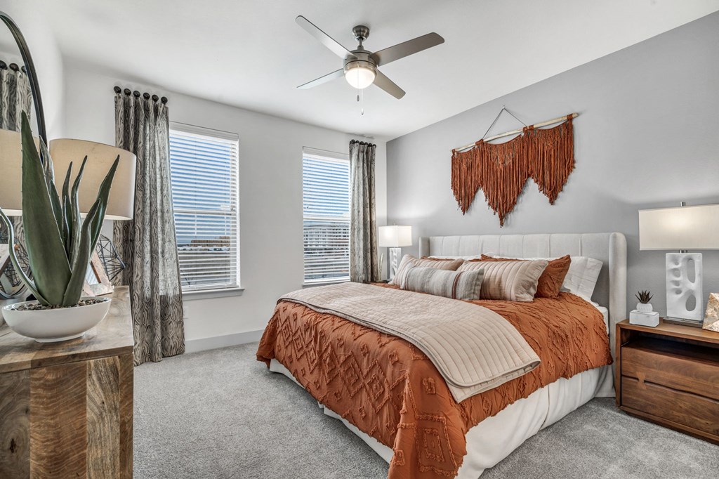 a bedroom with a bed and a ceiling fan