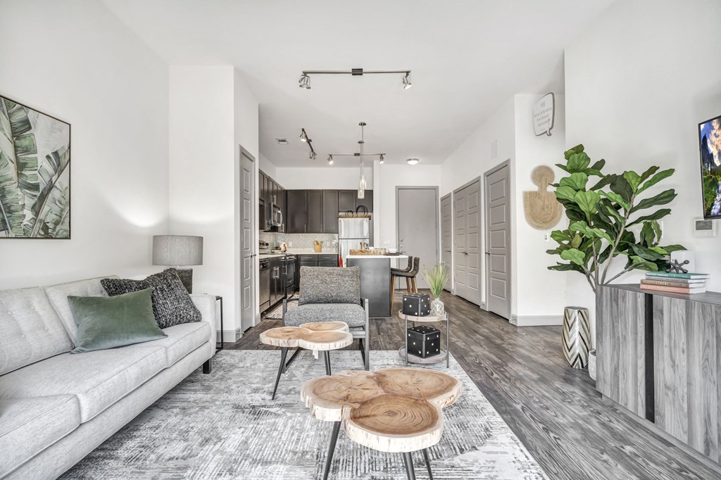 a living room with white walls and hardwood floors