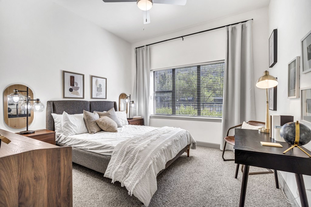 a bedroom with a bed and desk in a 555 waverly unit