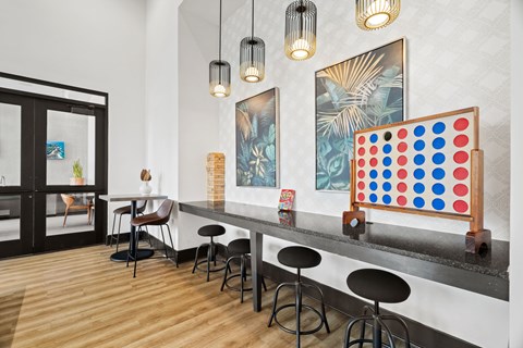 A bar area with a shelf and a framed game on it.