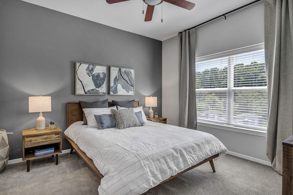 a bedroom with a bed and a ceiling fan