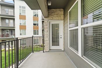 the outlook of the entrance to an apartment building with a balcony