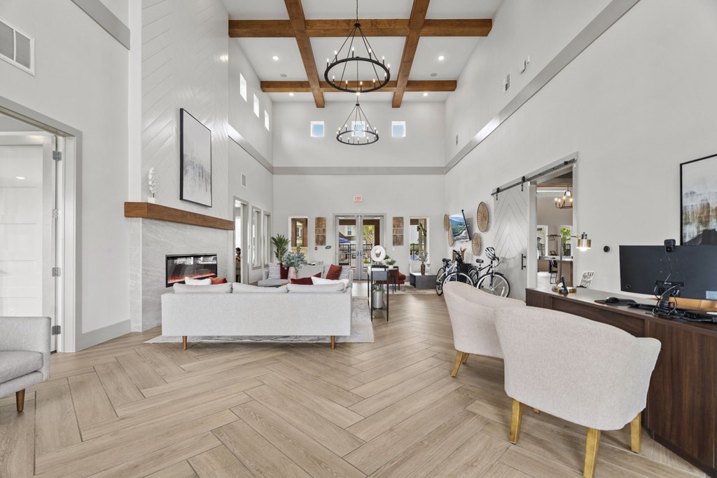 A modern living room with a white sofa and a wooden floor.
