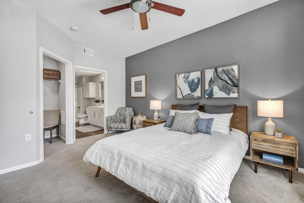 a bedroom with a bed and a ceiling fan