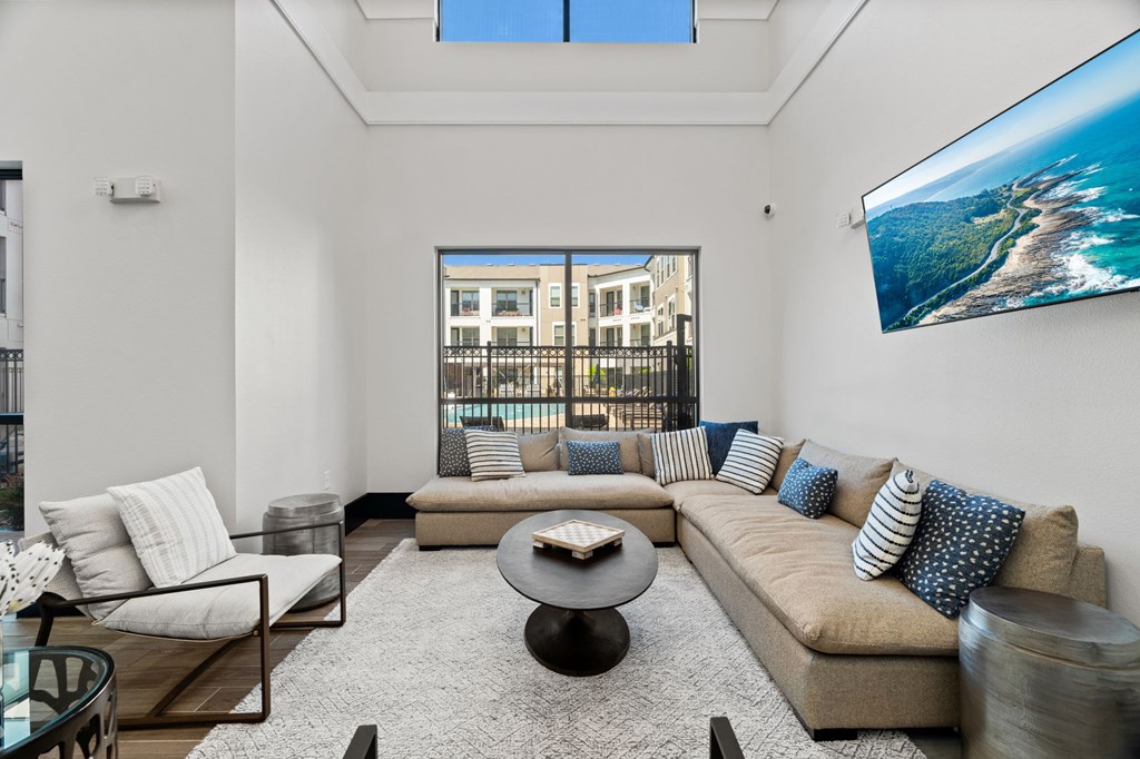 A modern living room with a large sofa and a coffee table.