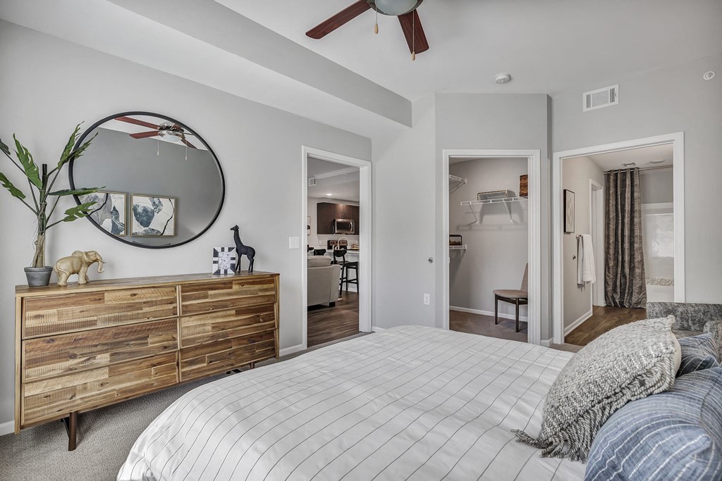 a bedroom with a bed and a mirror