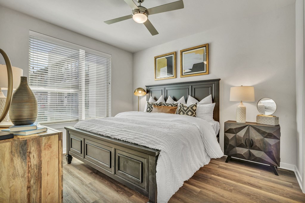 a bedroom with a bed and a ceiling fan