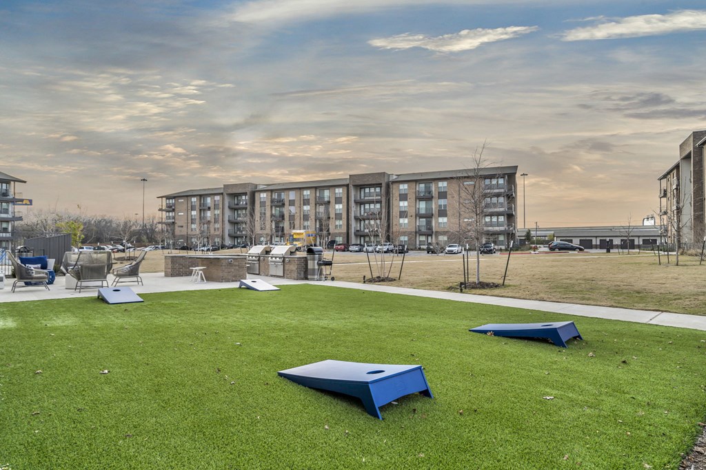 a park with blue benches in front of a building