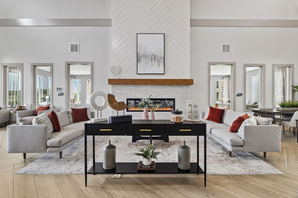 A modern living room with a black coffee table and grey sofas.