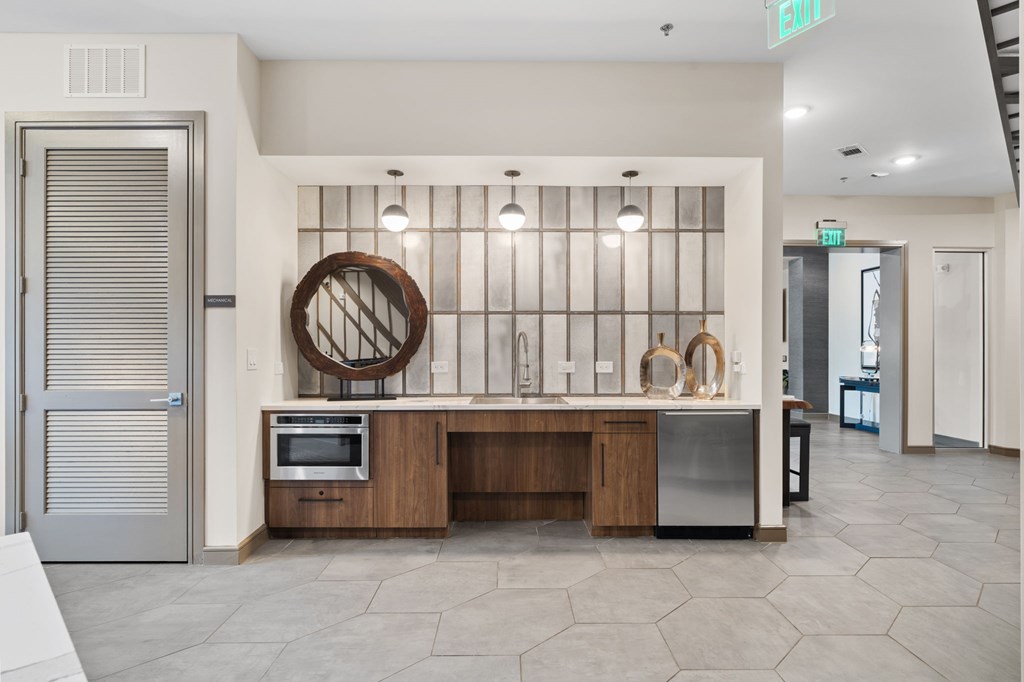 A modern kitchen with a wooden island and stainless steel appliances.