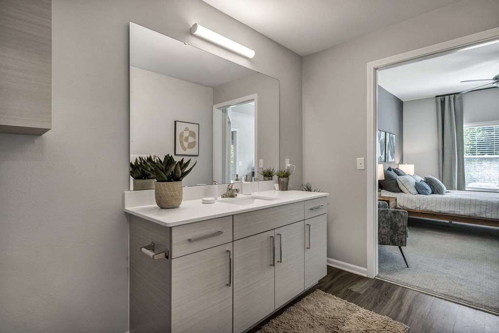an empty bathroom with a large mirror and a sink