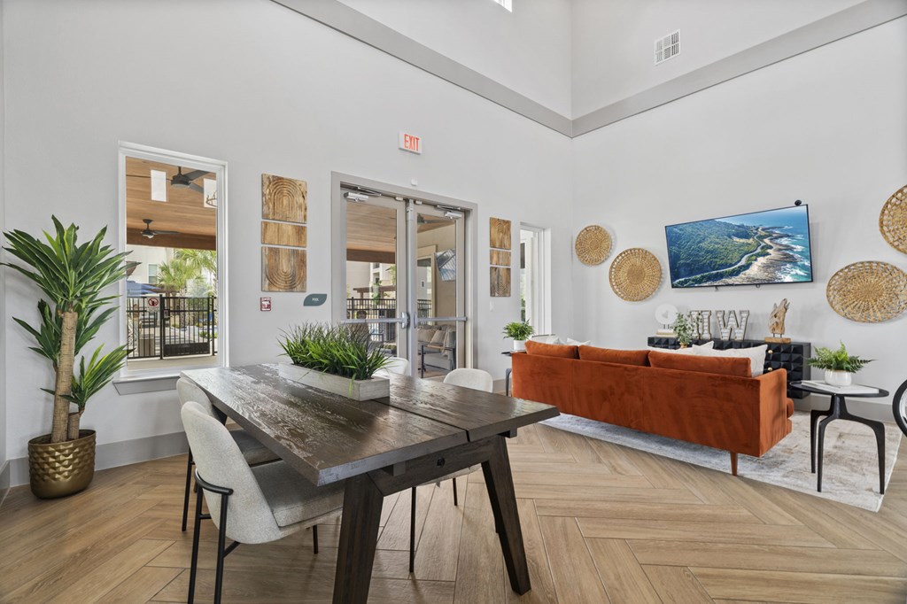 A modern dining room with a wooden table and chairs.