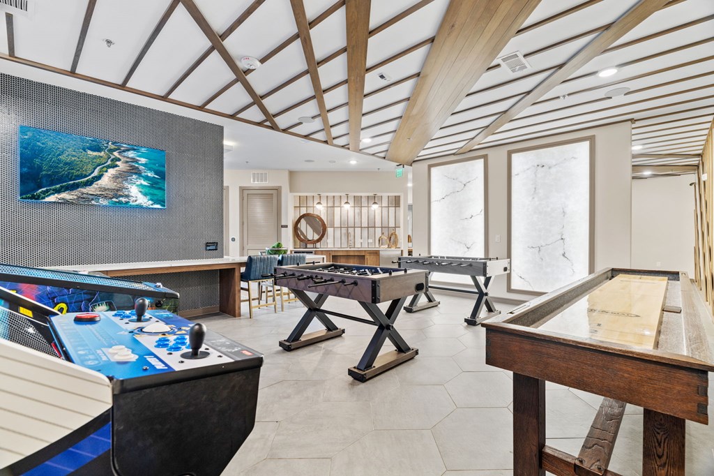 A room with a pool table and a ping pong table.