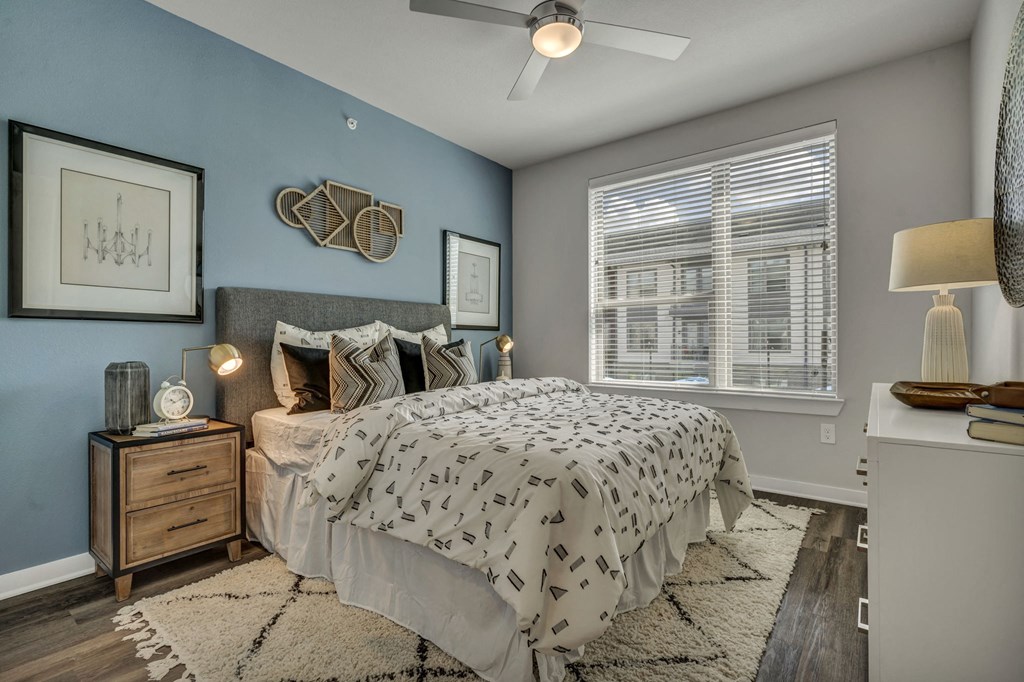 a bedroom with a bed and a ceiling fan