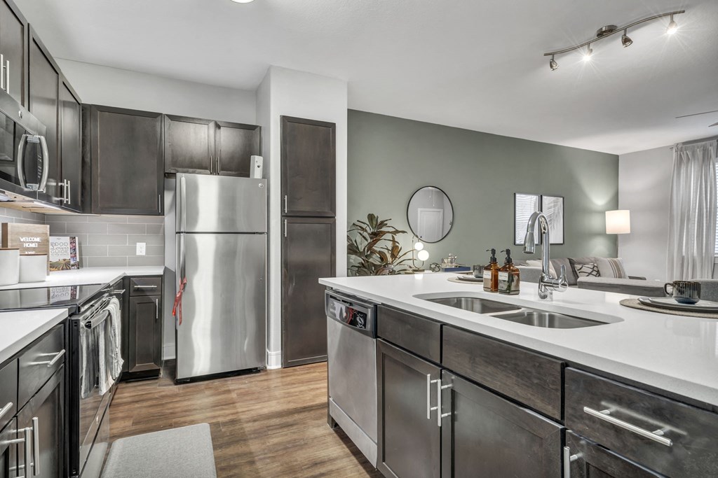 a kitchen with stainless steel appliances and a white counter top