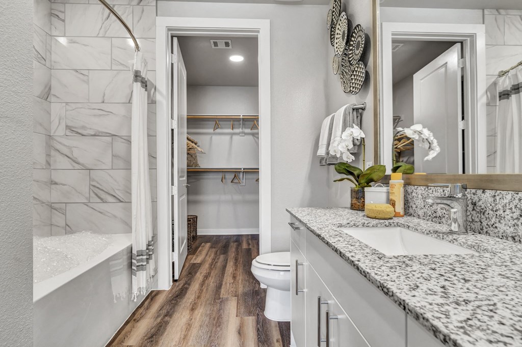 a bathroom with a shower and a sink and a toilet