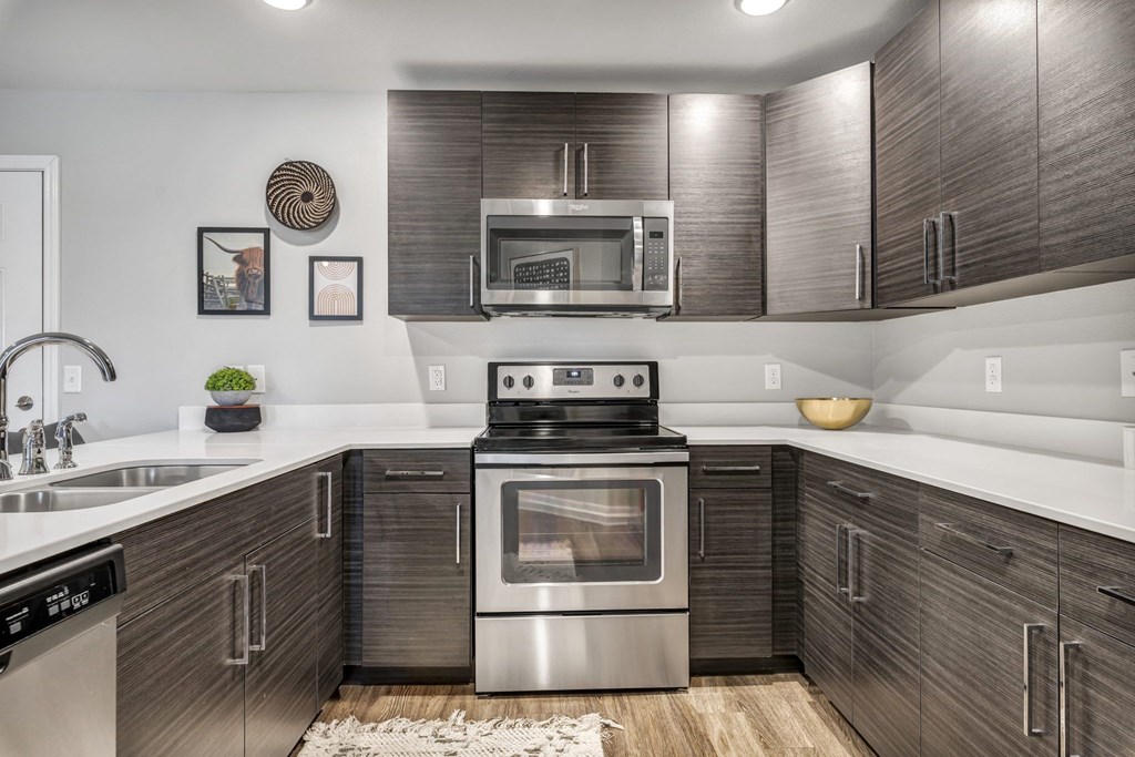 a kitchen with stainless steel appliances and wooden cabinets