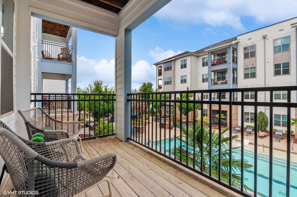 the view of the pool from the balcony of an apartment building