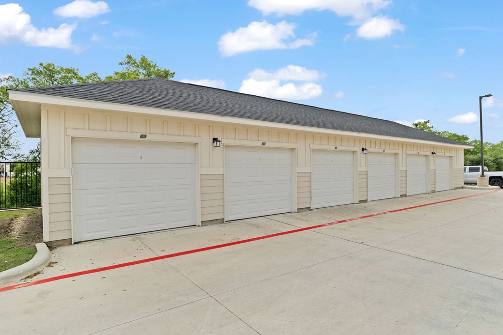 A row of white garage doors are closed.