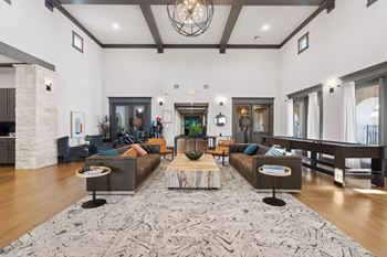 a living room with couches and a rug