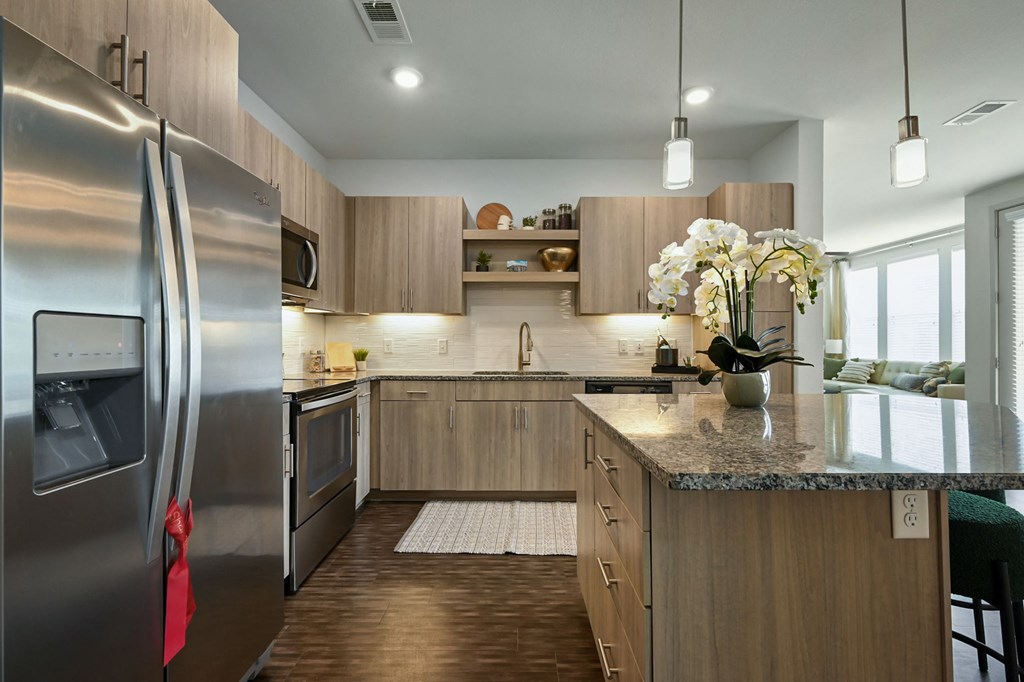 a kitchen with stainless steel appliances and wooden cabinets