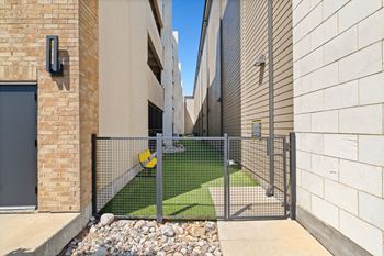 A modern house with a metal gate and a small garden.