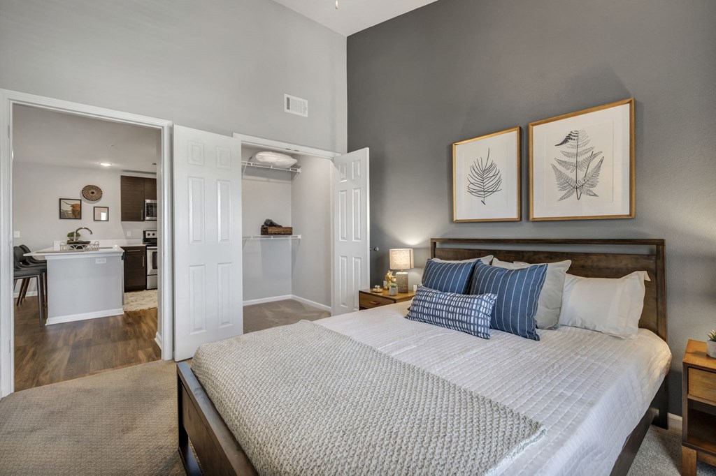 a bedroom with a bed and a bathroom with a sink