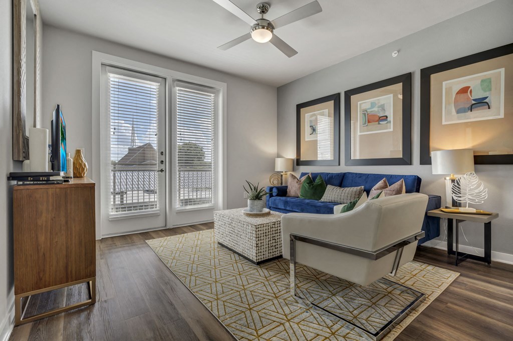 an open living room with windows and a ceiling fan