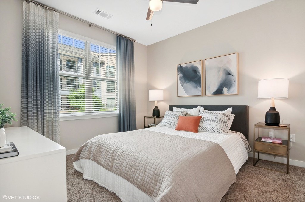 a bedroom with a bed and a large window