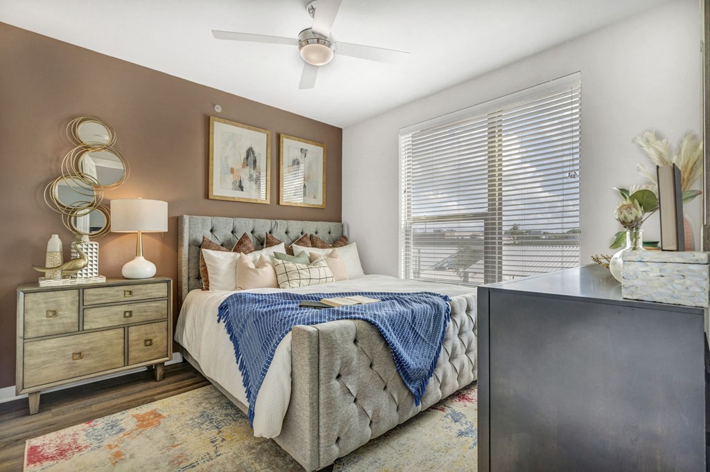 a bedroom with a bed and a ceiling fan