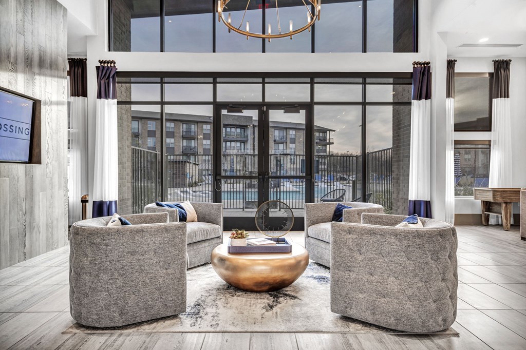 a living room with couches and chairs and a large window