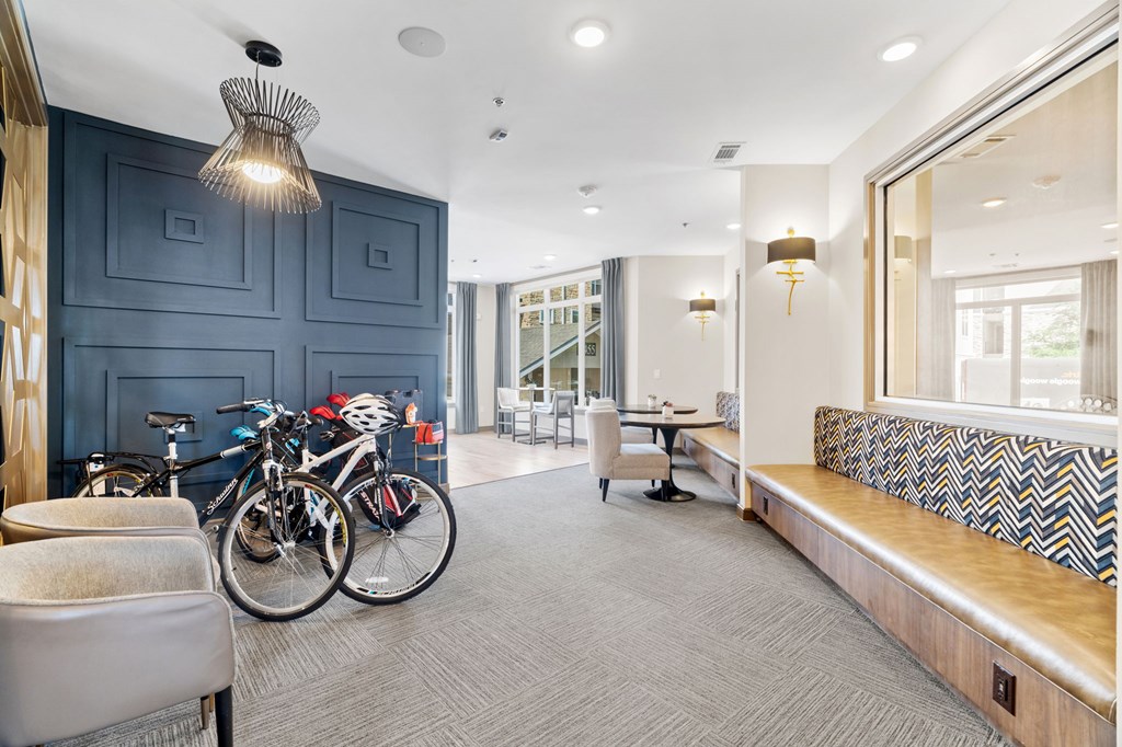 A room with a bicycle and a bench.