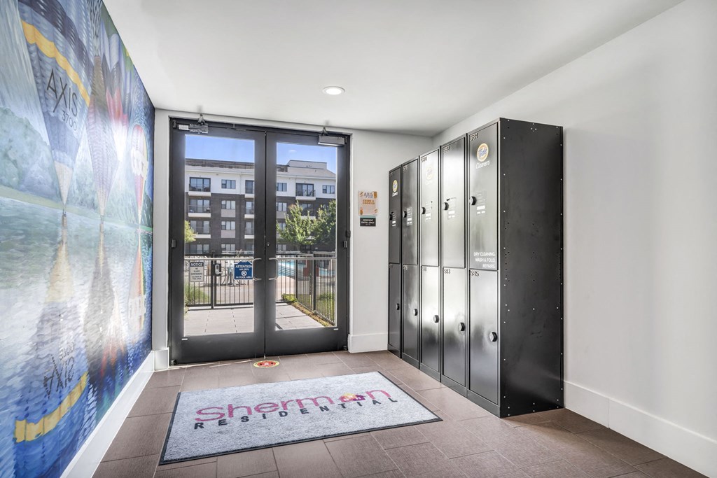 a locker area with a large mural on the wall and a door that leads to a balcony