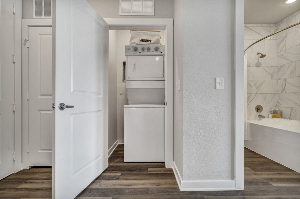 a white kitchen with an oven and a refrigerator